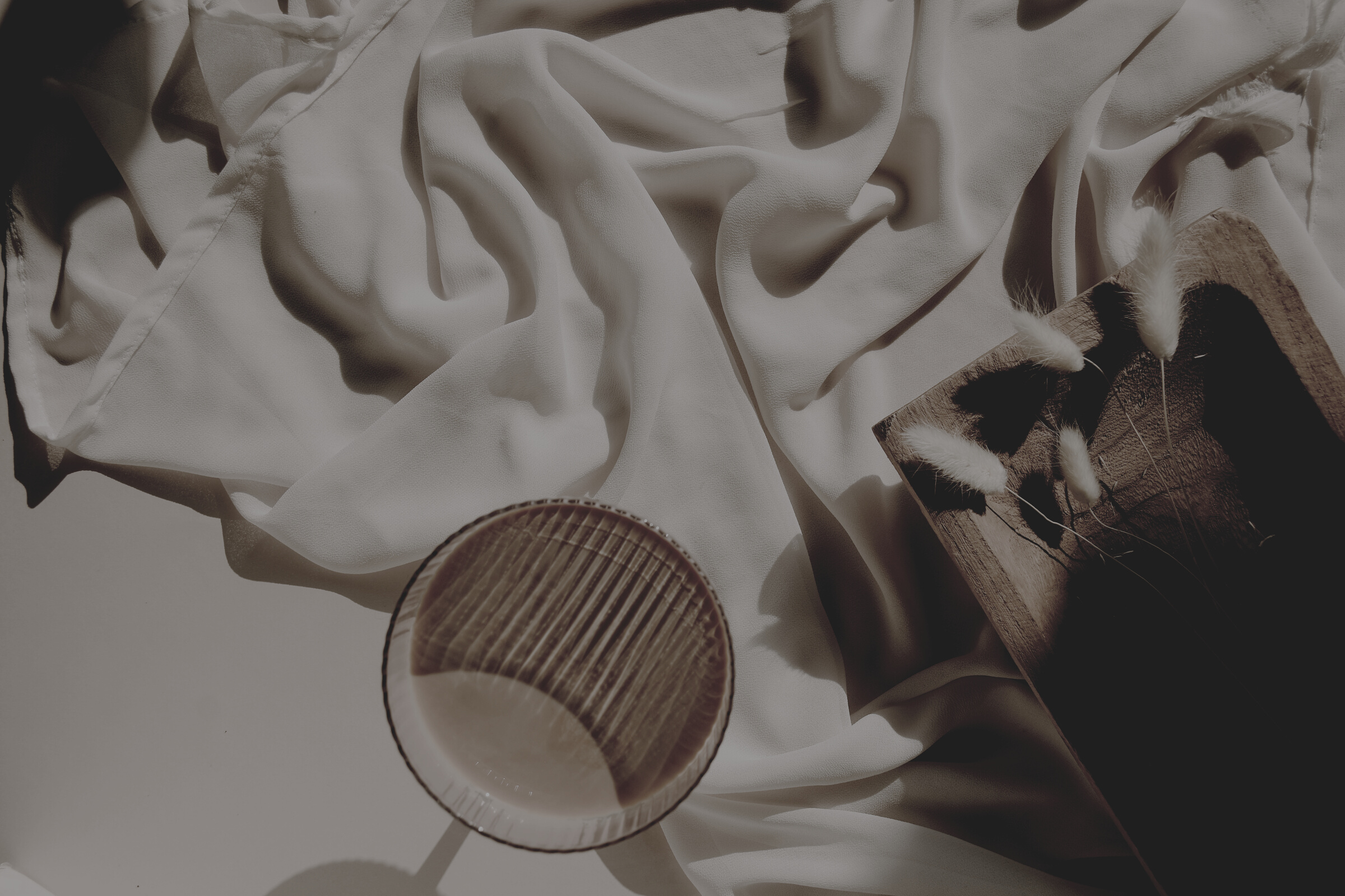 Brown Glass on White Cloth
